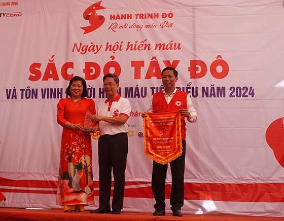 Ông Nguyễn Hà Thanh - Trưởng Ban Tổ chức Hành trình đỏ Trung ương tặng cờ lưu niệm cho ông Nguyễn Thực Hiện, Phó Chủ tịch UBND thành phố và tặng biểu trưng cho bà Huỳnh Thanh Thảo, Chủ tịch Hội Chữ thập đỏ TP. Cần Thơ