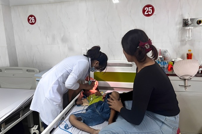 Bác sĩ khoa nhi tổng hợp - Bệnh viện Đa khoa vùng Tây Nguyên thăm khám cho bệnh nhi hóc dị vật đường thở (ảnh: Quang Nhật)