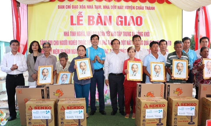 Lãnh đạo tỉnh Tây Ninh và đại diện đơn vị đồng hành trao ảnh chân dung Bác Hồ và quà tặng cho các gia đình tại khu tập trung xã Đồng Khởi, huyện Châu Thành