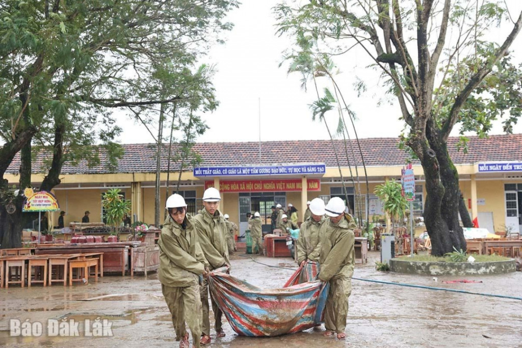Lực lượng chức năng hỗ trợ dọn dẹp, vệ sinh tại Trường Tiểu học Trần Quốc Toản, phường Đông Hòa (Ảnh: Minh Thuận)